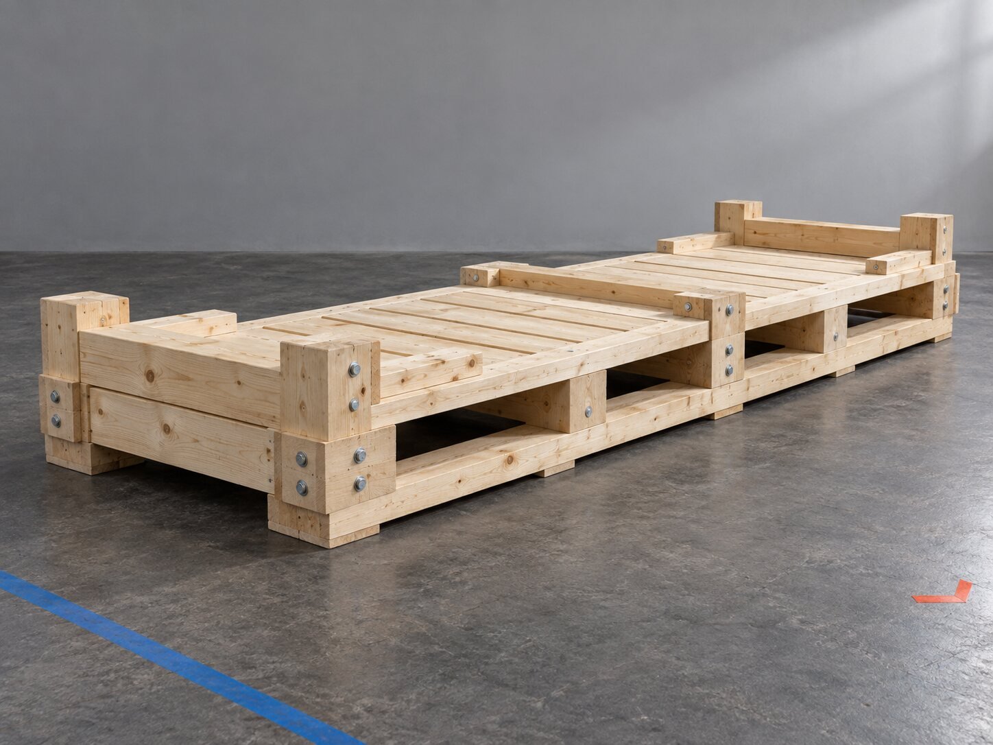Long reinforced wooden machinery skid with doubled runners